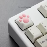 The ZOMOPLUS White-Pink Kitty Paw Keycap offers a realistic feel, durable ABS base, and compatible with MX switches and available in various colors.