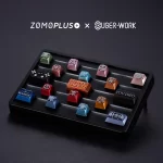 ZOMOPLUS X BUGER WORK Metal Keycap Storage Box with keycaps displayed at a low angle, easily transforming into a photo frame.