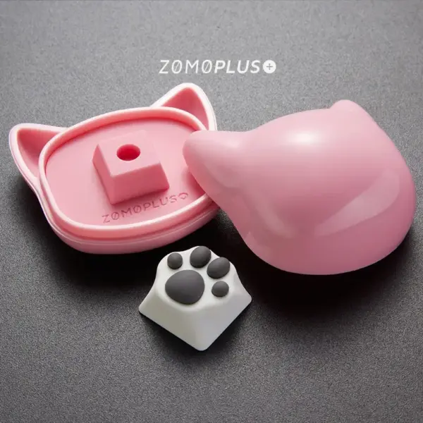 ZOMOPLUS white-grey kitty paw keycap displayed alongside its cat-themed storage box, ideal for keyboard enthusiasts.