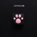 Close-up top view of ZOMOPLUS black-pink kitty paw keycap, emphasizing the soft silicone paw texture and strong ABS base.