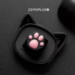 ZOMOPLUS black-pink kitty paw keycap resting in the cat face storage box, highlighting its fun and functional design.