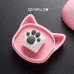 White-grey ZOMOPLUS kitty paw keycap placed in its storage box, a perfect balance of playful design and functional storage.