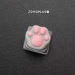 Detailed view of ZOMOPLUS kitty paw keycap, showcasing the soft, realistic silicone paw pads and sleek ABS base with patented bonding.