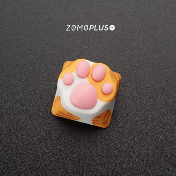 Close-up of ZOMOPLUS kitty paw artisan keycap in orange cat design, showcasing playful charm for keyboard and cat lovers.