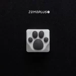 ZOMOPLUS kitty paw keycap in white-grey, viewed from above, with soft, bouncy silicone and durable ABS construction.