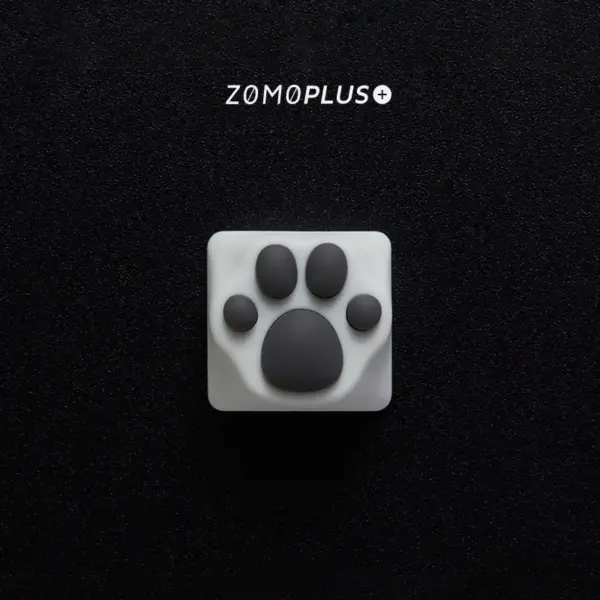 ZOMOPLUS kitty paw keycap in white-grey, viewed from above, with soft, bouncy silicone and durable ABS construction.