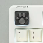 This ZOMOPLUS keycap showcases its playful design from above, perfect for any cat lover's keyboard setup!