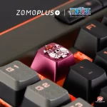 Side angle of ZOMOPLUS Ace Keycap on keyboard, featuring vibrant anodized finish and strong aluminum material.