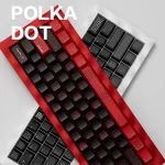 Overlapping SINOKEY Polka Dot Keycap Sets in red-black and black, installed on keyboards for a layered style showcase.