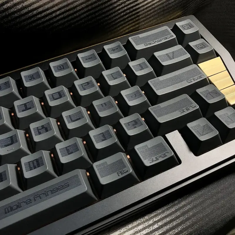 Industrial-style black keycap set with geometric moire pattern and sharp edges.