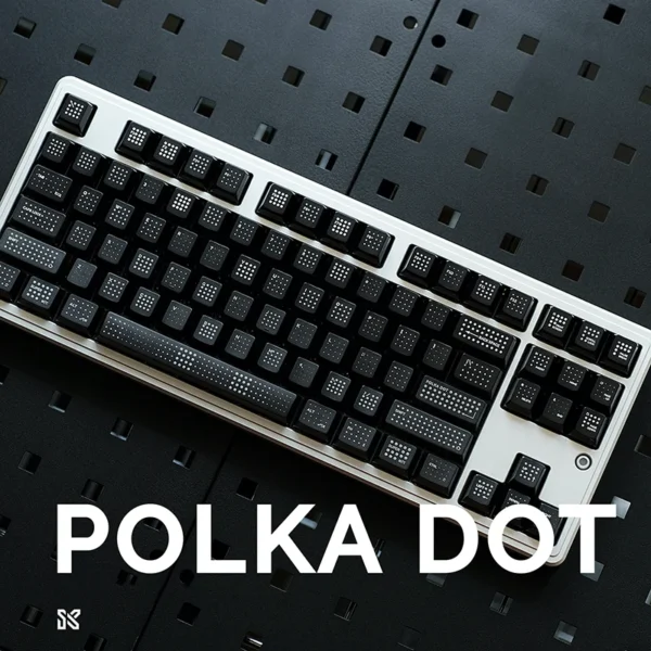 Complete mechanical keyboard with black polka dot keycaps installed, white keyboard frame, professional gaming setup